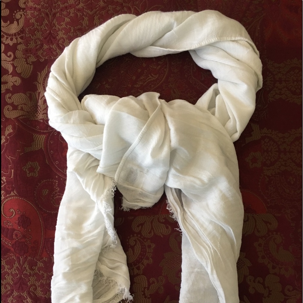 Solid white scarf with faint floral design in it.